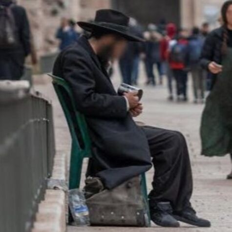 poor man sitting on a chair in jerusalem