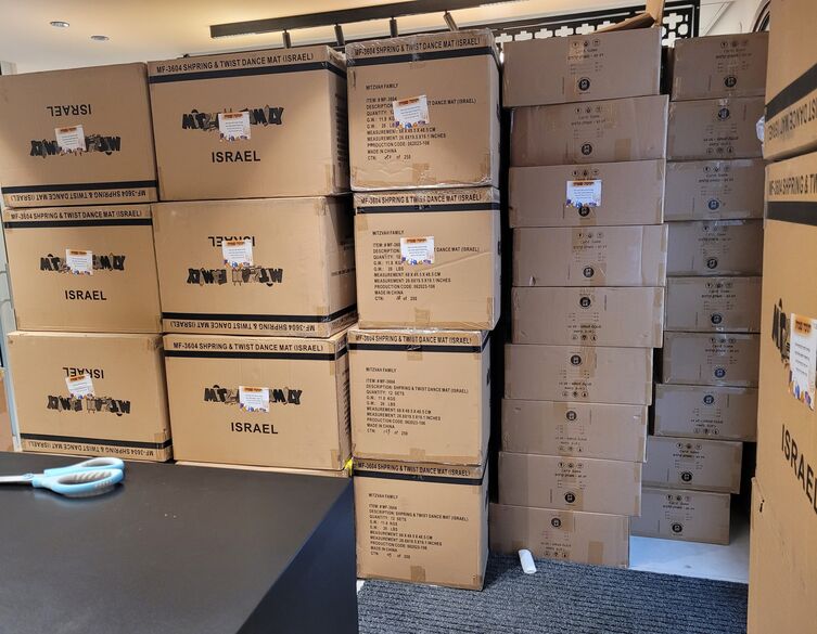 brown shipping boxes of games in an office