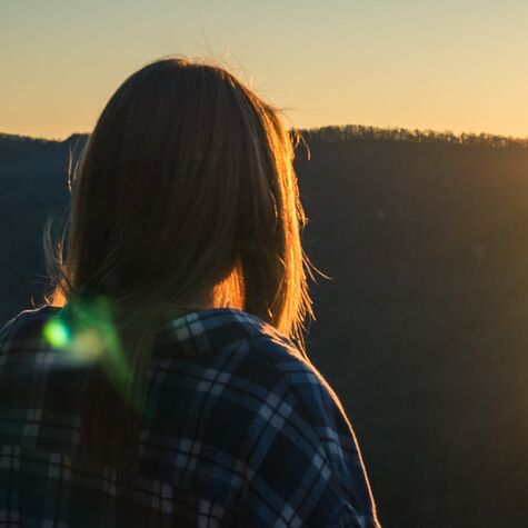 woman facing mountains