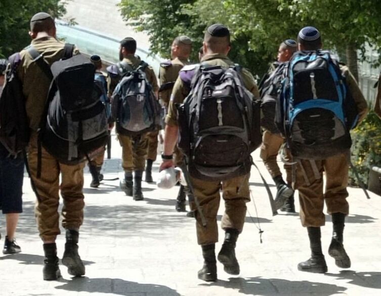 group of idf soldiers walking with backpacks