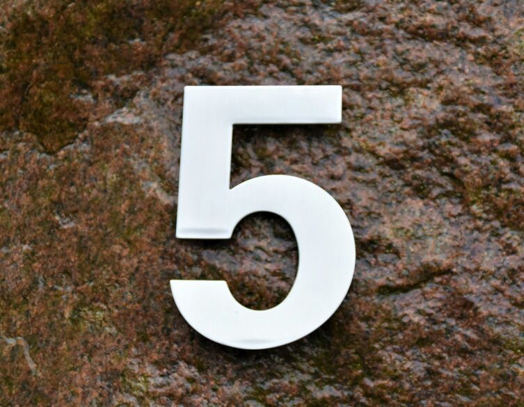 white number five on a stone background