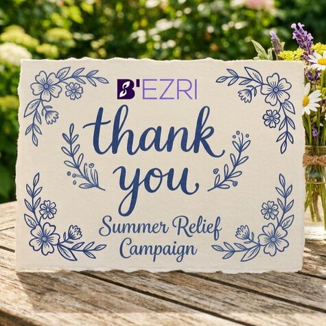 thank you card on a table with flowers next to it
