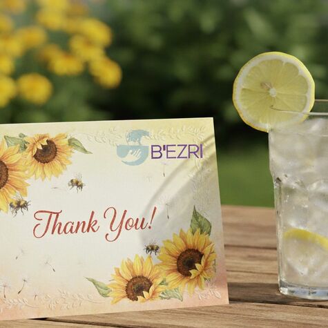 thank you note next to a glass of lemonade on a table