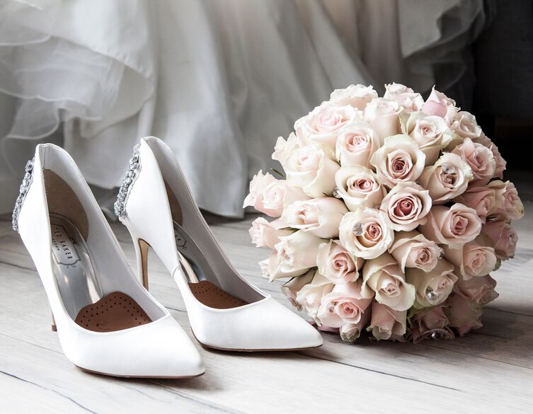 bridal dress, white shoes and pink flowers