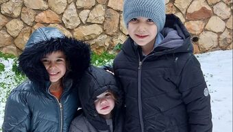 kids in coats in the snow