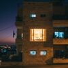 Israeli apartment lit up at night view through the window of a menorah
