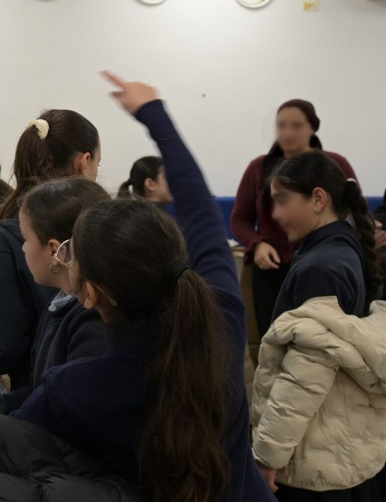 girls picking out coats at a distribution
