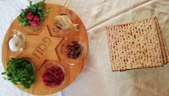 seder plate next to matzos