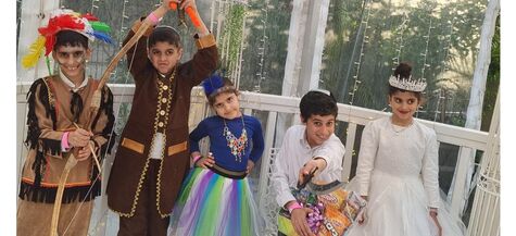 five children in assorted purim costumes