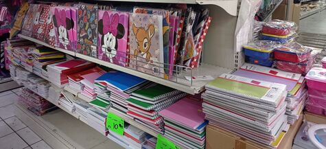 piles of notebooks and folders in a store